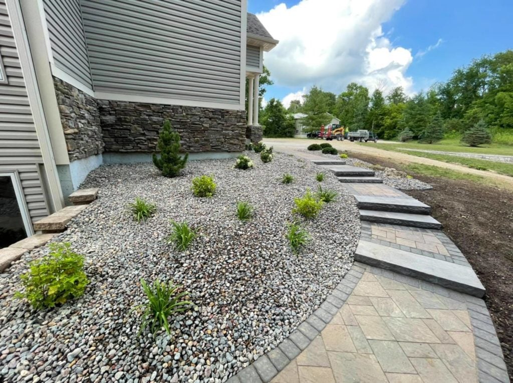 Paver walkway with steps plantings and landscape rock