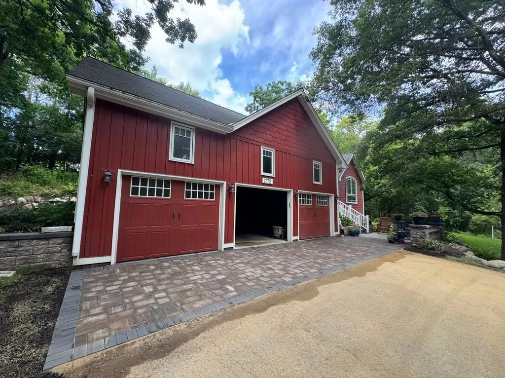 Completed paver apron in front of a red garage