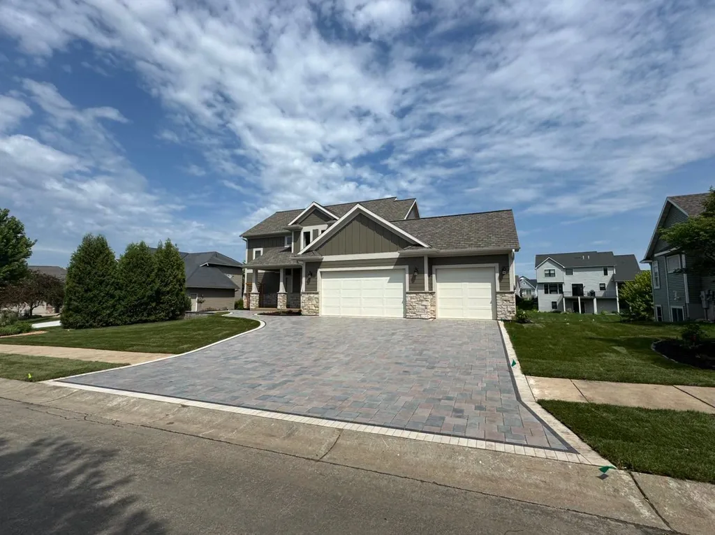 Completed paver driveway leading to a house