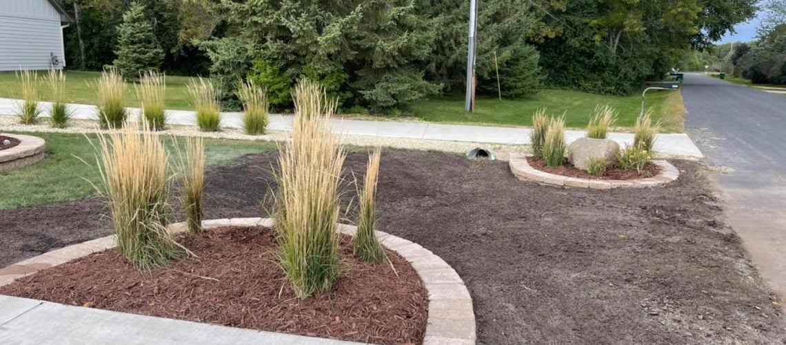 Front yard landscaping with ornamental grass, mulch & retaining walls